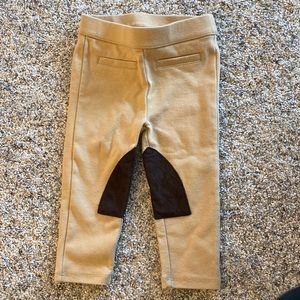 Like new, 12-18 month equestrian leggings with brown quilt patch.